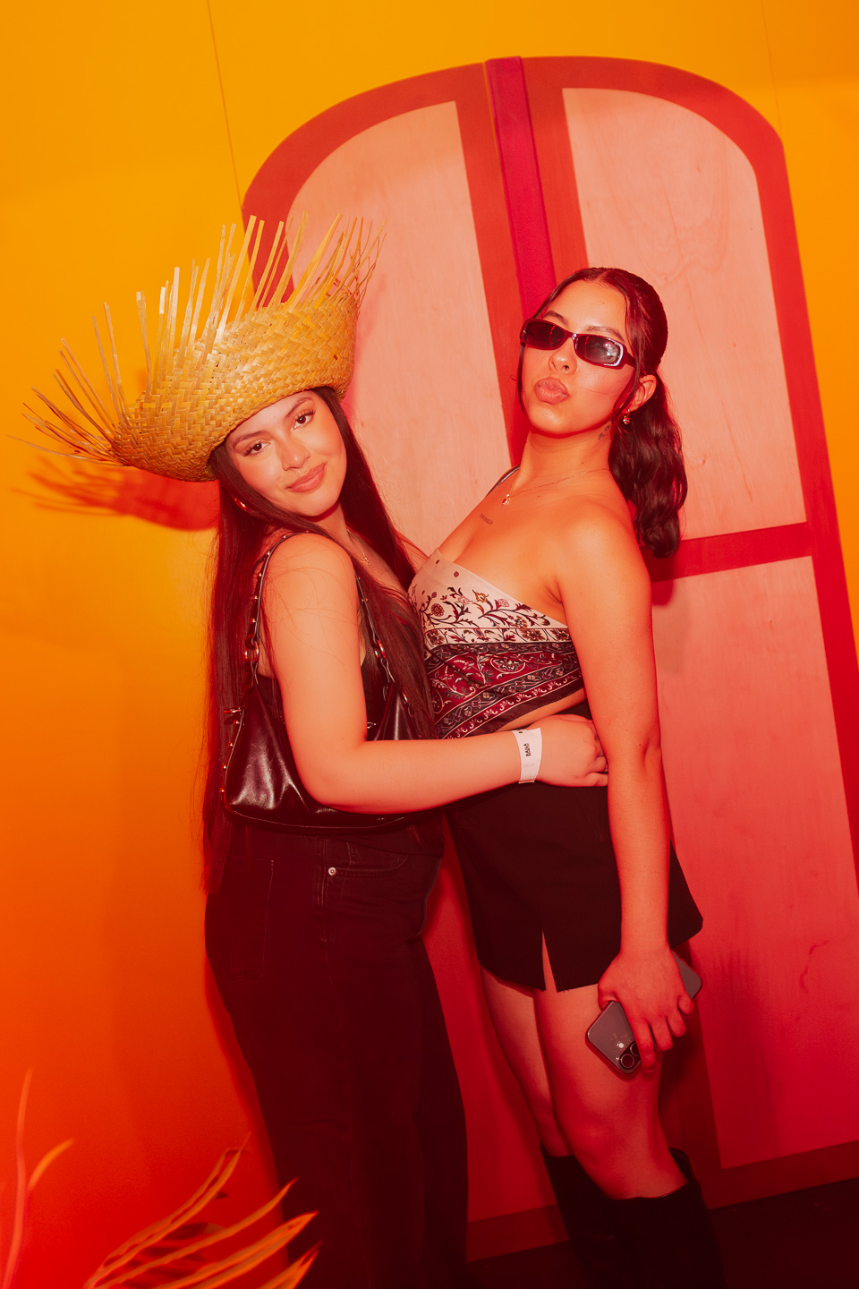 Girls posing in front of casita wall