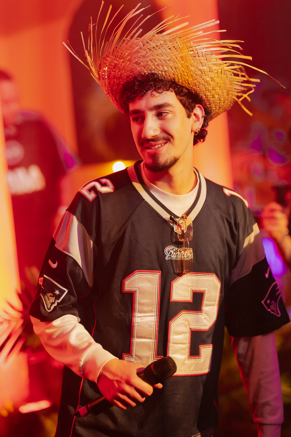 MC in Brady jersey with straw hat