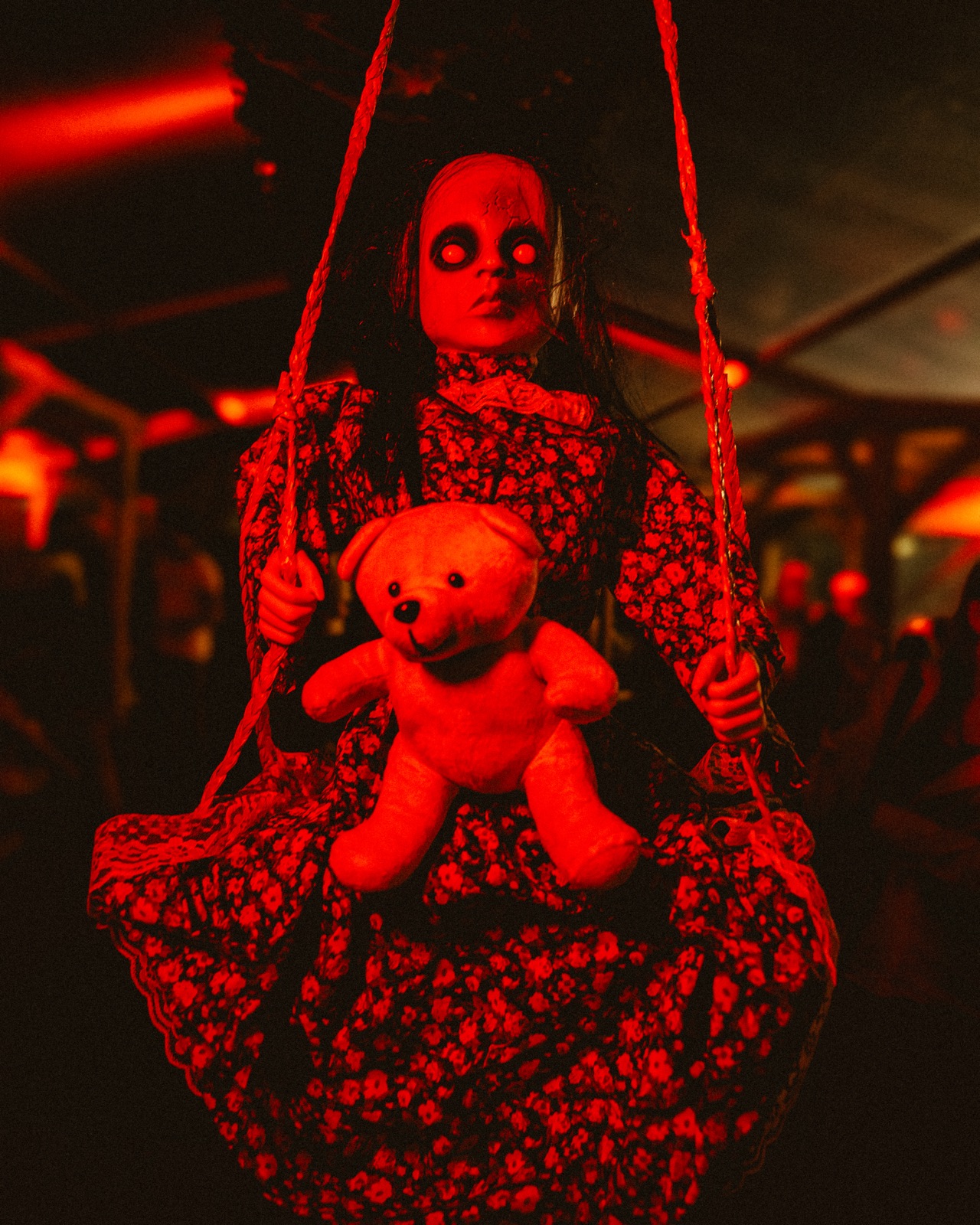 Haunted doll prop hanging on a swing